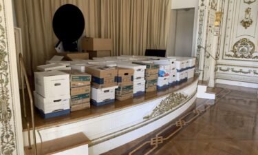 Boxes of documents are stored inside the Mar-a-Lago Club's White and Gold Ballroom in this photo included in Donald Trump's federal indictment.