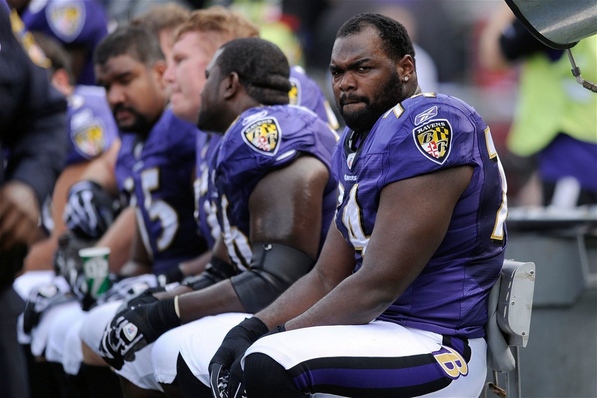 <i>Nick Wass/AP</i><br/>Baltimore Ravens offensive tackle Michael Oher sits on the beach during the first half of an NFL football game against the Buffalo Bills in Baltimore