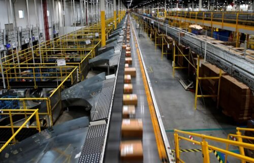 A fast-moving conveyor moves packages to delivery trucks during operations on Cyber Monday at Amazon's fulfillment center in Robbinsville