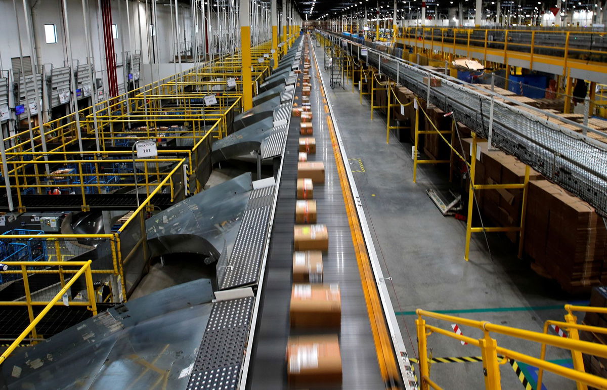 <i>Mike Segar/Reuters</i><br/>A fast-moving conveyor moves packages to delivery trucks during operations on Cyber Monday at Amazon's fulfillment center in Robbinsville