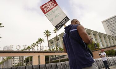 Picketers carry signs outside Fox studios on August 14 in Los Angeles. Writers and heads of the four major studios are set to meet for a second consecutive day on September 21.