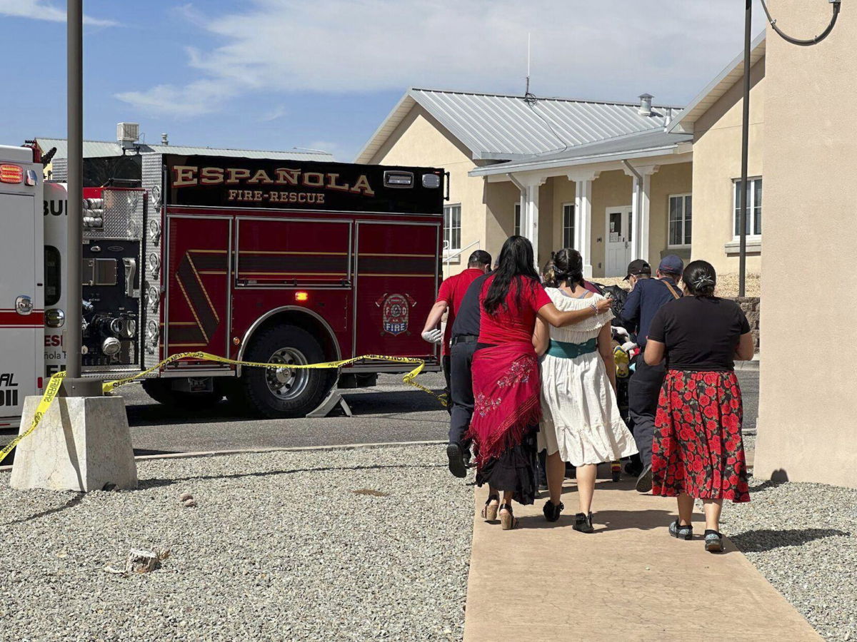 <i>Luis Sánchez Saturno/Sante Fe Mexican/AP</i><br/>First responders arrive at the scene of a shooting Thursday