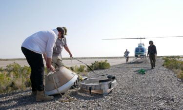 A training model of the sample return capsule is seen during a drop test. Parachutes will slow the capsule's descent.