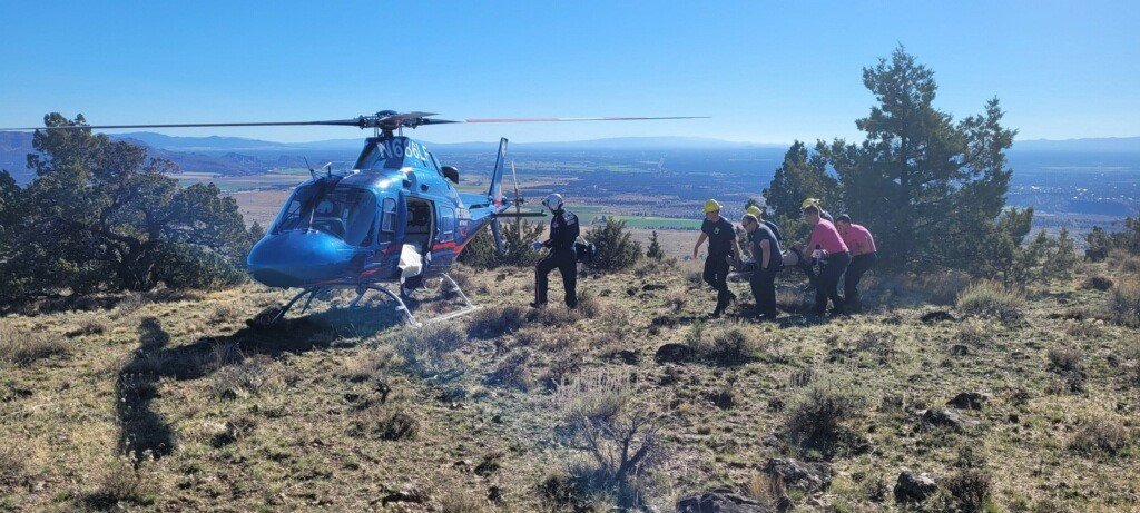Jefferson County first responders at Juniper Butte bring injured paraglider to Life Flight helicopter for trip to St. Charles Bend