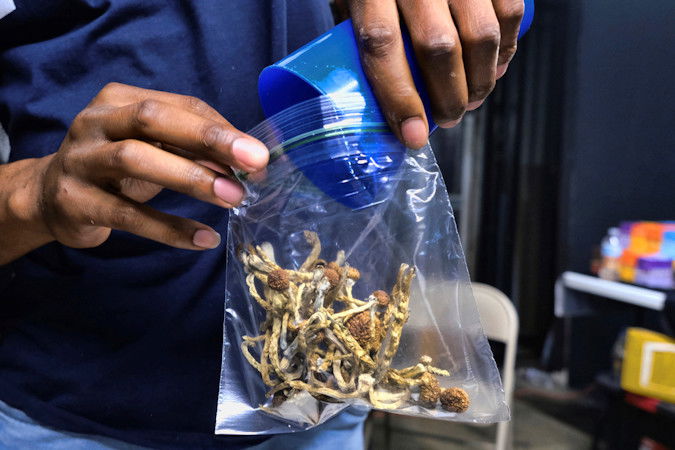  A vendor bags psilocybin mushrooms at a cannabis marketplace on May 24, 2019, in Los Angeles