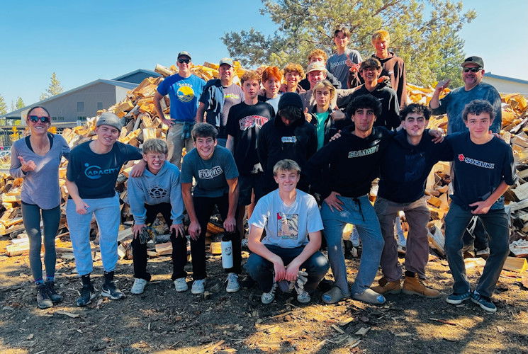 Summit HS boys soccer team gathers for a photo while helping Saturday at the Nativity Wood Lot
