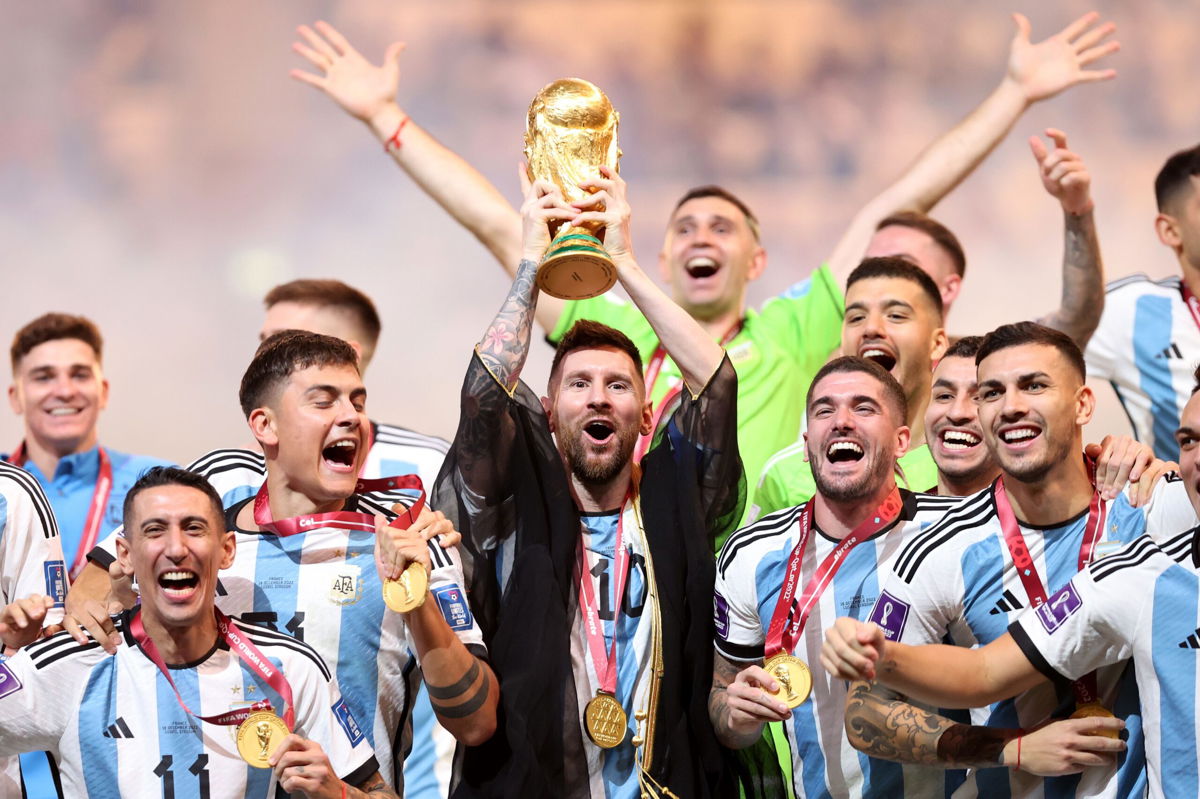 <i>Julian Finney/Getty Images</i><br/>Lionel Messi lifts aloft the World Cup trophy after Argentina won the 2022 edition of the tournament in Qatar.