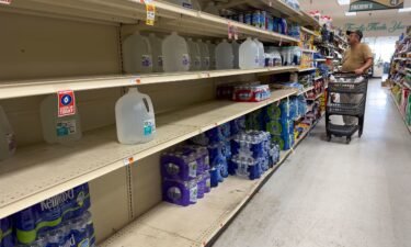 Mostly empty shelves of bottled water at Fremin's Food Market in Port Sulphur