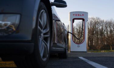 A Tesla charging station is seen at the Chesapeake House Travel Plaza off I-95 in Maryland in March 2022. The Justice Department is investigating whether or not Tesla cars can live up to the EPA’s official estimates of how far they can go on a single charge.
