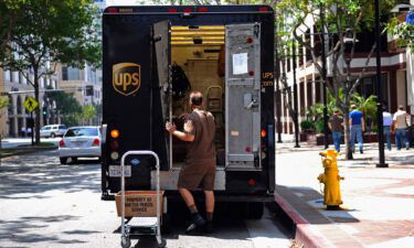 A UPS driver walks back to his truck after making a delivery in Glendale