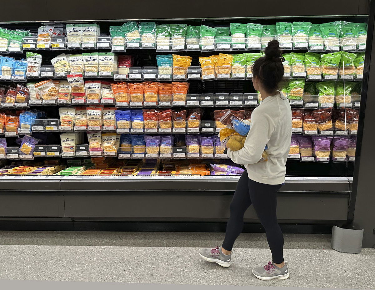 <i>David Zalubowski/AP</i><br/>A shopper peruses cheese offerings at a Target store on October 4 in Sheridan