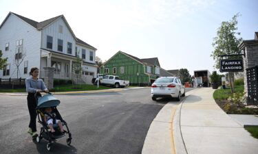 A person pushes a child in a stroller in a new housing development in Fairfax