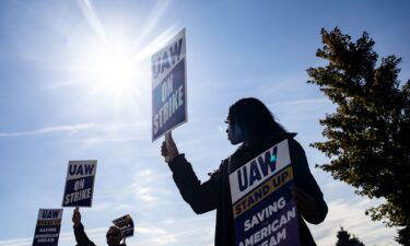 A "UAW On Strike" sign held on a picket line outside the Stellantis Sterling Heights Assembly Plant in Sterling Heights