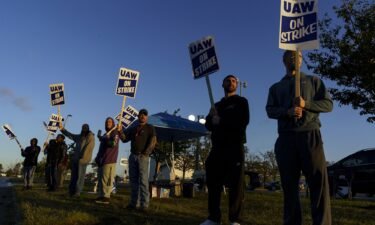 Factory workers and UAW union members form a picket line outside the Ford Motor Co. Kentucky Truck Plant in the early morning hours on October 14