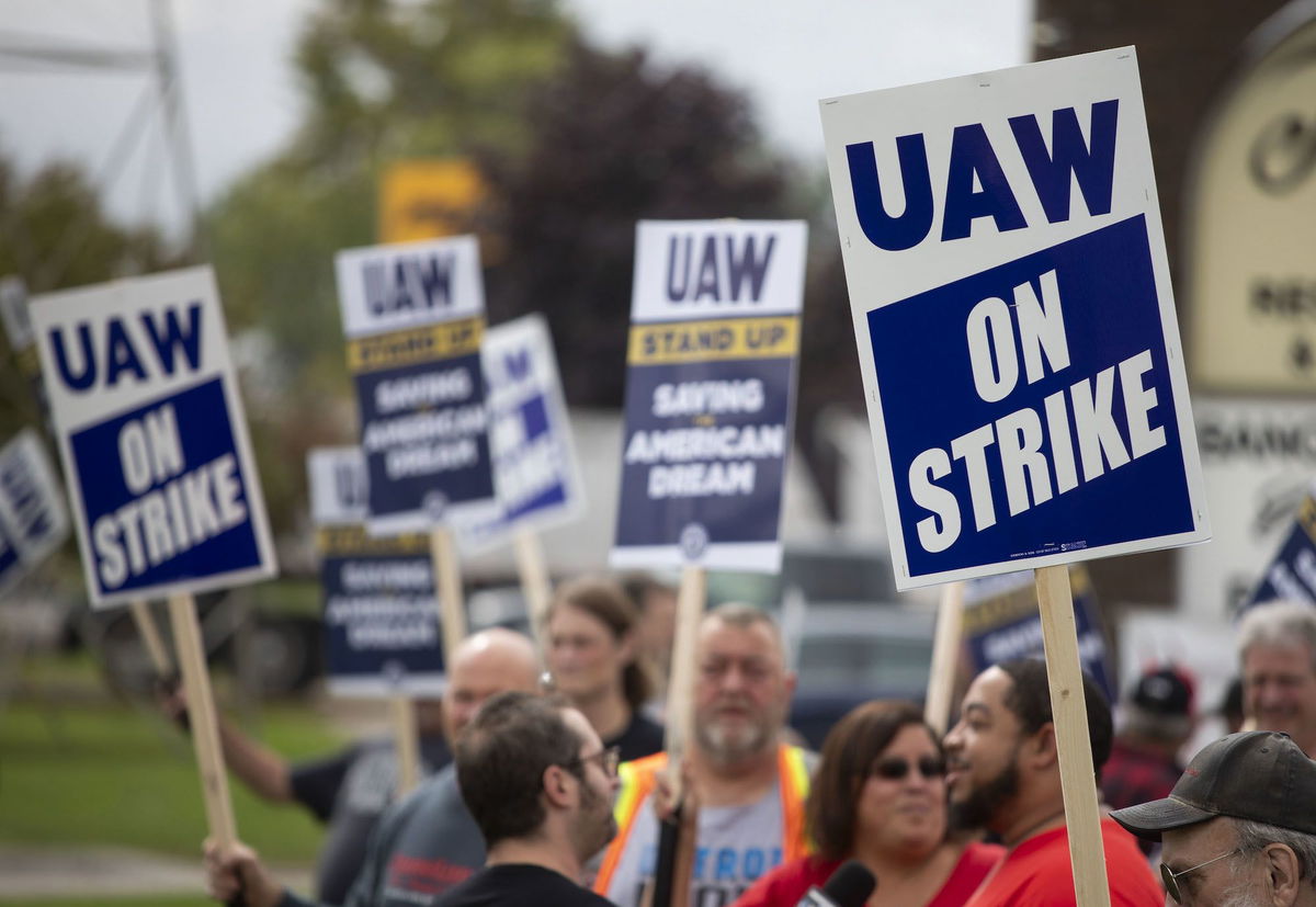 <i>Bill Pugliano/Getty Images/FILE</i><br/>United Auto Workers members strike the General Motors Lansing Delta Assembly Plant on September 29