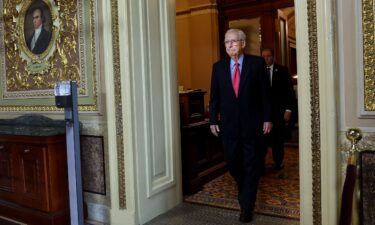 Senate Minority Leader Mitch McConnell walks from the Senate Chambers at the Capitol on September 6