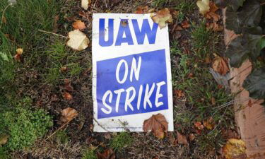 A strike sign lays in the grass outside of Ford's Chicago Assembly Plant on October 26