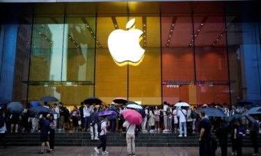 People stand outside an Apple Store as Apple's new iPhone 15 officially goes on sale across China