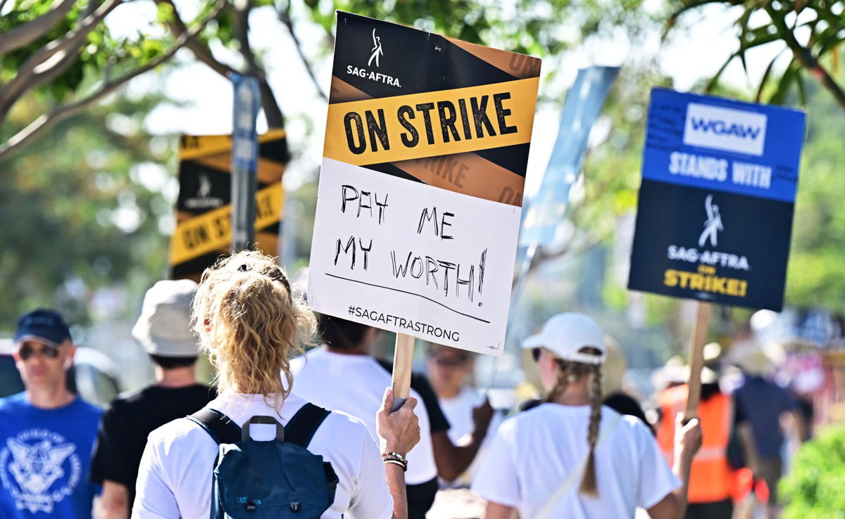 <i>Frederic J. Brown/AFP/Getty Images</i><br/>SAG-AFTRA members picket outside of Netflix's building on day 99 of their strike against the Hollywood studios in Hollywood