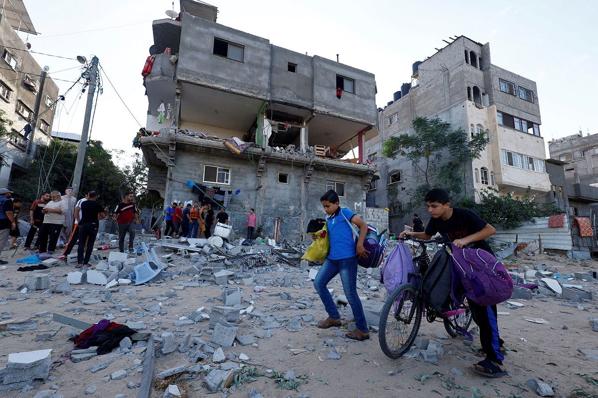 <i>Abed Khaled/AP</i><br/>Palestinians leave their homes following Israeli bombardments on Gaza