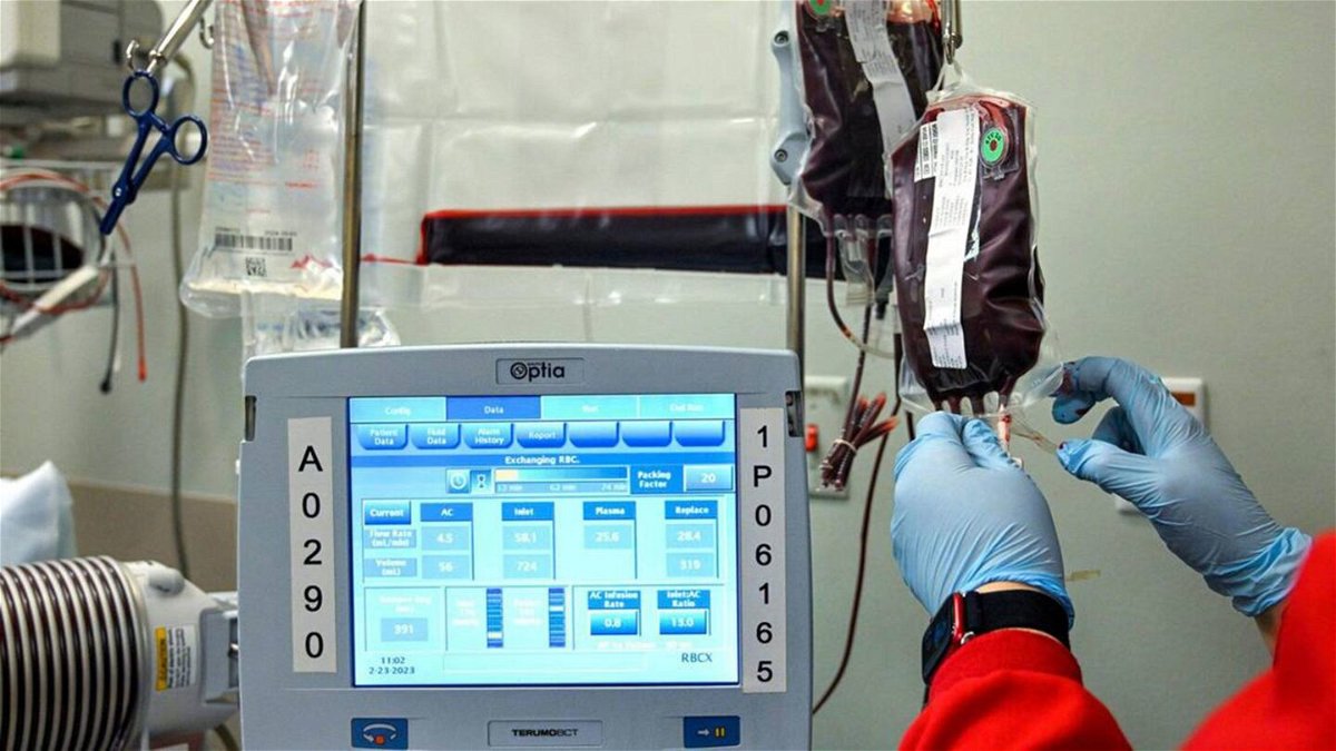 <i>Tammy Ljungblad/The Kansas City Star/Tribune News Service via Getty Images</i><br/>A worker from the Community Blood Center hangs a bag of blood during a transfusion for Kevin Wake at the Sickle Cell Center at University Health on March 7.