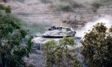 An Israeli battle tank moves near a position along the border with the Gaza Strip in southern Israel on October 31