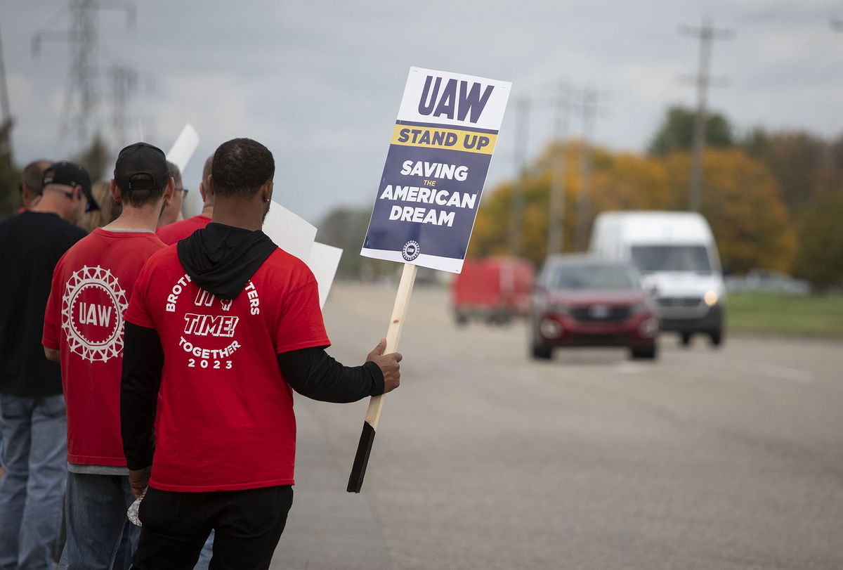 <i>Bill Pugliano/Getty Images</i><br/>United Auto Workers members strike the General Motors Lansing Delta Assembly Plant on September 29 in Lansing