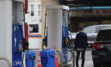 A person pumps gas at an Exxon gas station on October 06