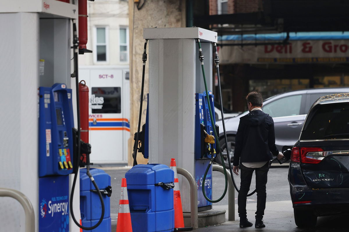 <i>Michael M. Santiago/Getty Images</i><br/>A person pumps gas at an Exxon gas station on October 06