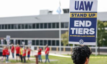 UAW members and workers hold signs outside the Ford's Chicago Assembly Plant after walking off their jobs in Chicago