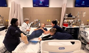 Thomas Jefferson University College of Nursing students practice transferring a patient.