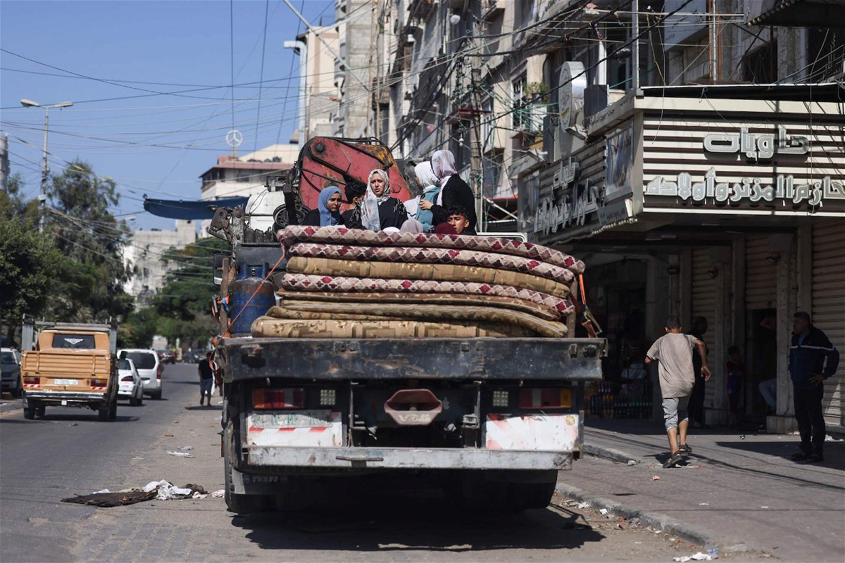 <i>Mohammed Abed/AFP/Getty Images</i><br/>Palestinians with their belongings flee to safer areas in Gaza City after Israeli air strikes on October 13.