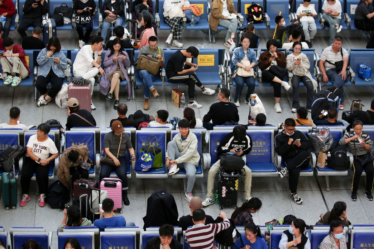 <i>Stringer/AFP/Getty Images</i><br/>Passengers waiting for trains on October 6