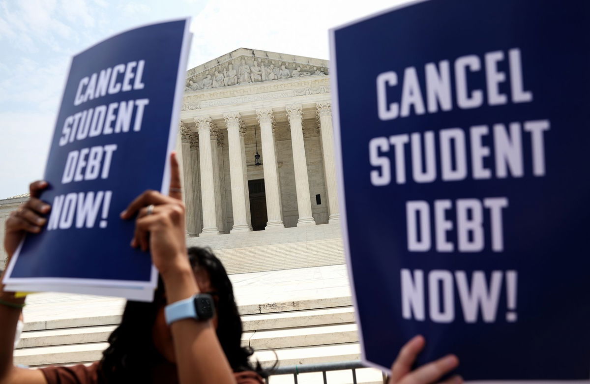 <i>Kevin Dietsch/Getty Images</i><br/>Student debt relief activists participate in a rally at the Supreme Court on June 30