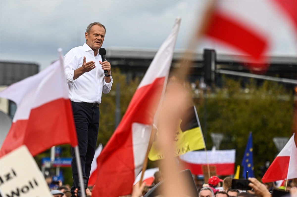 <i>Rafal Oleksiewicz/AP</i><br/>People waved Polish and EU flags at Sunday's rally.