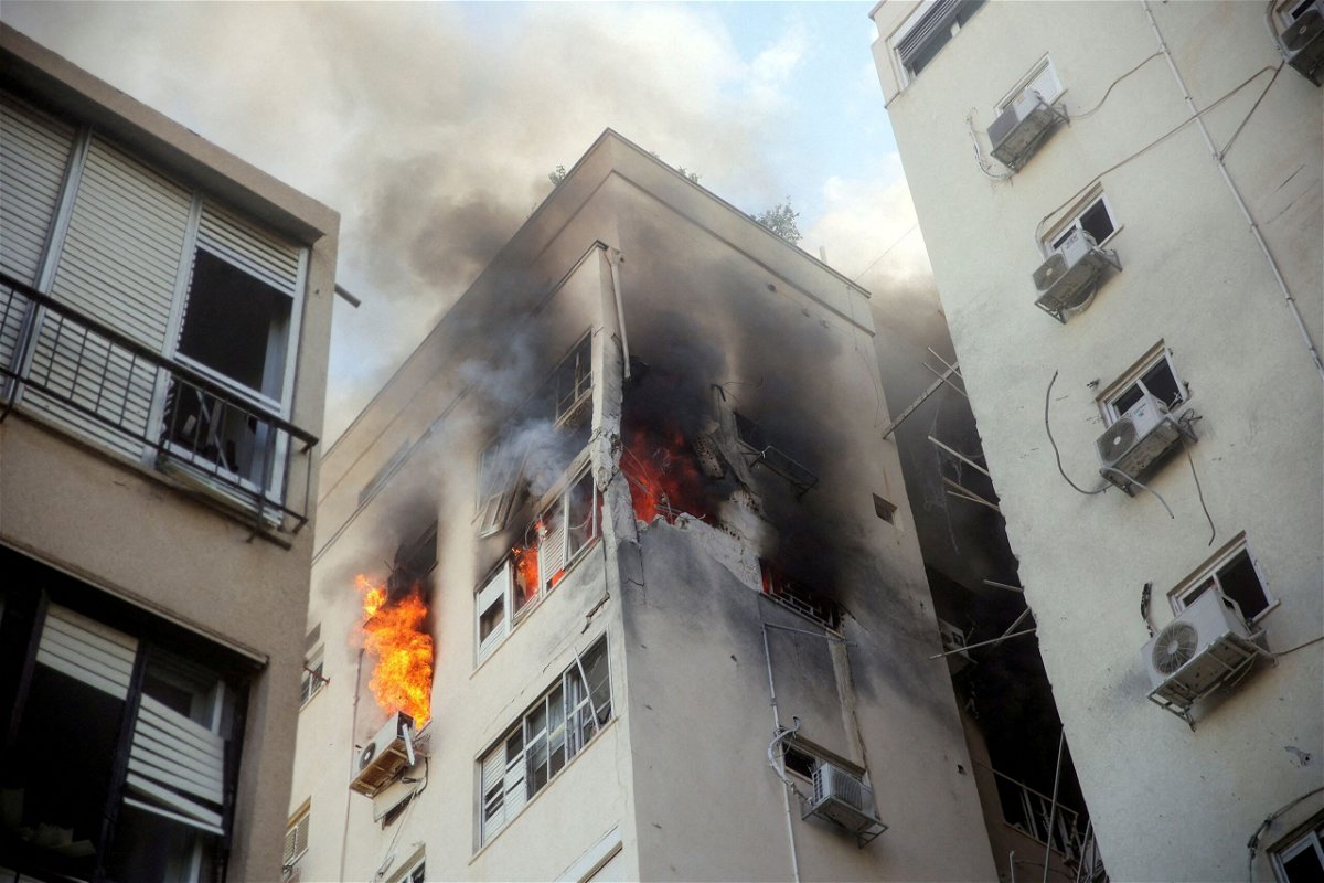 <i>Itai Ron/Reuters</i><br/>A building is ablaze following rocket attacks in Tel Aviv