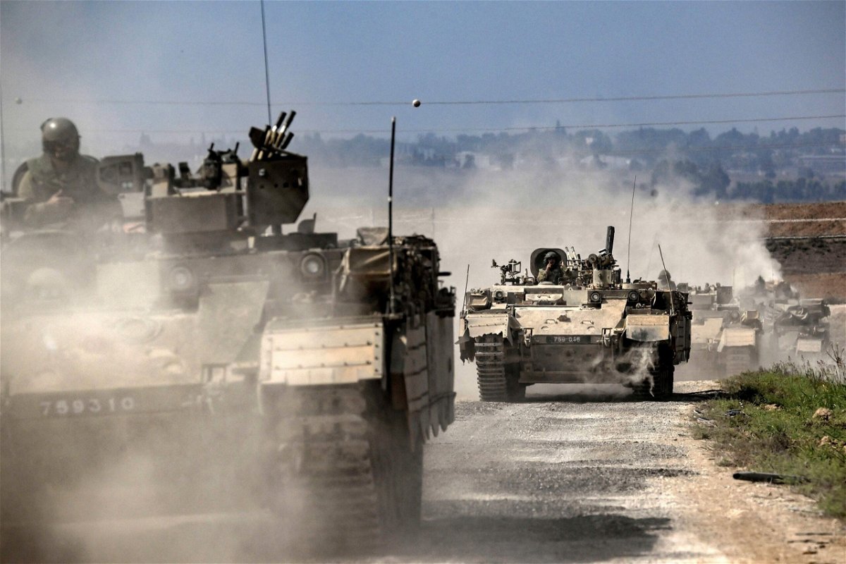 <i>Aris Messinis/AFP/Getty Images</i><br/>Israeli army Puma armored personnel carriers move in a column near the Gaza border in southern Israel on October 14. A new CNN poll shows that the American public expresses deep sympathy for the Israeli people.