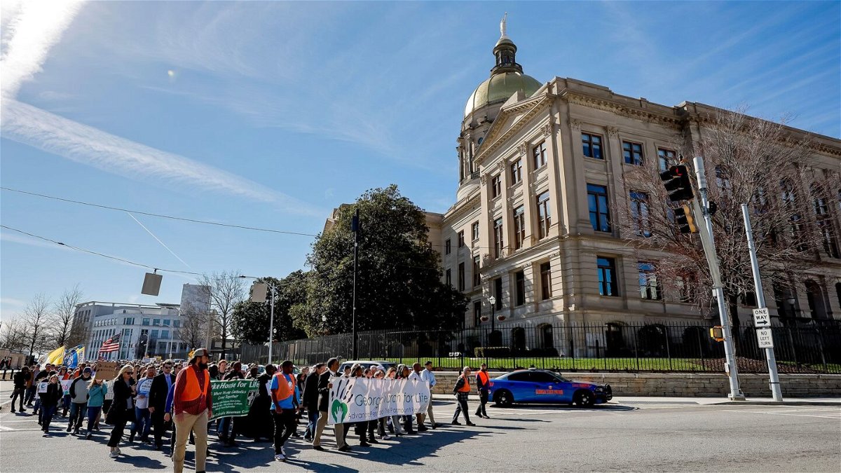 <i>Erik S. Lesser/EPA-EFE/Shutterstock</i><br/>People walk past the Georgia State Capitol while participating in the Georgia March for Life & Memorial Service & Rally in downtown Atlanta