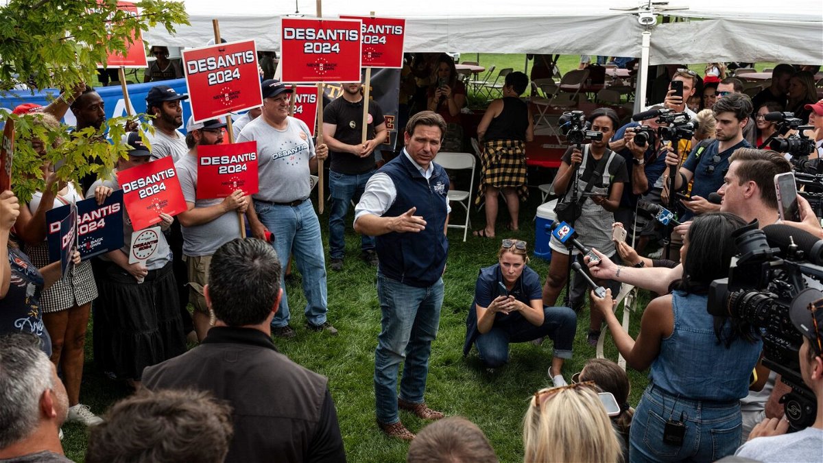 <i>Jordan Gale/The New York Times/Redux</i><br/>Florida Gov. Ron DeSantis speaks to reporters during an Iowa State University football game in Ames on September 9.