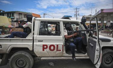 Police officers patrol a Haiti neighborhood amid gang-related violence in downtown Port-au-Prince on April 25