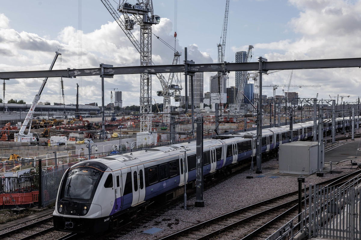<i>Dan Kitwood/Getty Images</i><br/>A train travels past construction on a HS2 site in London on October 3.
