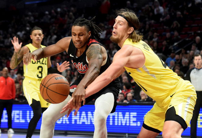 Portland Trail Blazers forward Jabari Walker, left, and Utah Jazz forward Kelly Olynyk, right, go after a loose ball during the first half of Wednesday night's NBA game
