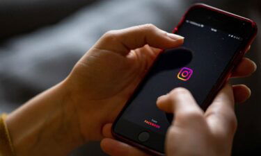 The logo of the Instagram app is seen on the screen of a smartphone in 2021.