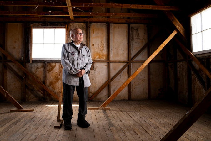 aul Tomita poses for a portrait in a historic barracks at Minidoka National Historic Site, Saturday, July 8, 2023, in Jerome, Idaho. Tomita, who had asthma as an infant, says the constant desert dust that seeped even into the barracks repeatedly sent him to the camp hospital. 