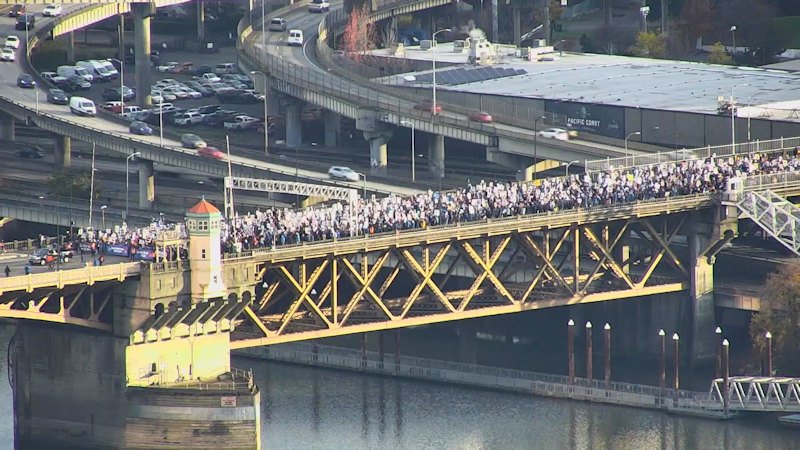 Striking teachers march across the Burnside Bridge in Portland