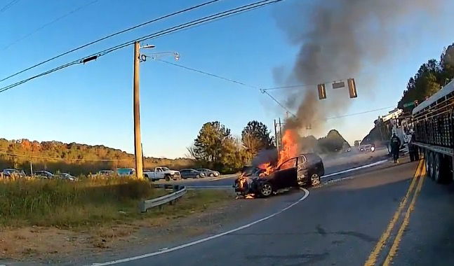 <i>Rome Police Department</i><br/>A Rome Police Department officer is being recognized after he helped free a mother and her son from their car just moments before it burst into flames
