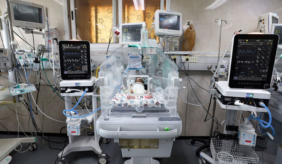 <i>Reuters</i><br/>Newborns are placed in a bed after being taken off incubators in Gaza's Al-Shifa hospital after power outage in Gaza City on November 12.