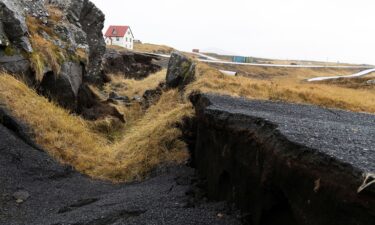 Cracks caused by volcanic activity emerge on a road in Grindavík