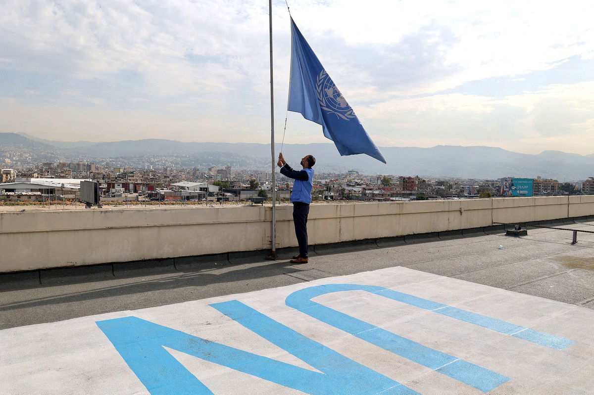 <i>Anwar Amro/AFP/Getty Images</i><br/>An UNRWA employee lowers the UN flag at the organization's offices in the Lebanese capital Beirut on November 13