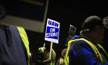 Factory workers and UAW union members form a picket line outside the Ford Motor Co. Kentucky Truck Plant in the early morning hours on October 12